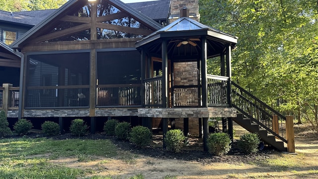 rear view of house featuring a sunroom