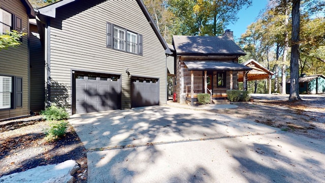 exterior space featuring a garage and covered porch