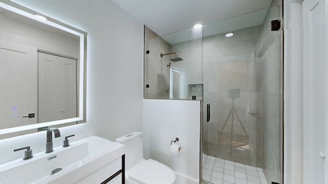 bathroom with vanity, toilet, and a shower with door