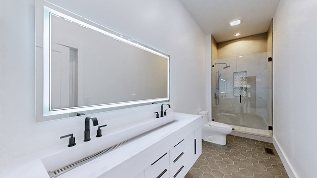 bathroom featuring toilet, vanity, an enclosed shower, and tile patterned floors