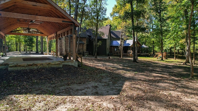 view of yard featuring ceiling fan, a playground, a patio, and a gazebo