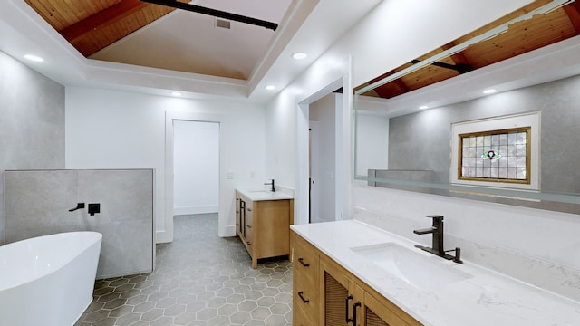 bathroom featuring vanity, tile patterned floors, and a bath