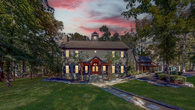 colonial house featuring a yard