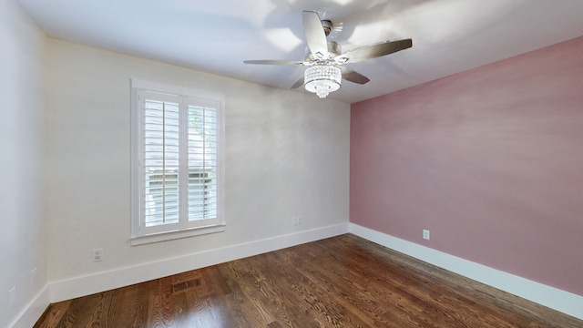 unfurnished room with ceiling fan and dark hardwood / wood-style flooring