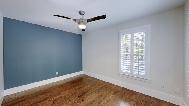 empty room with ceiling fan and wood-type flooring