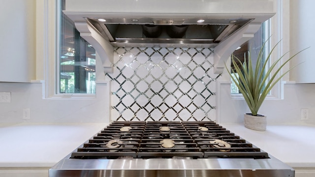 interior details featuring stainless steel range oven and wall chimney exhaust hood