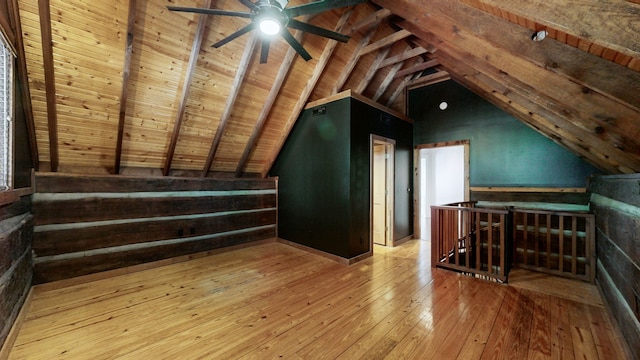 additional living space featuring wooden ceiling, light hardwood / wood-style flooring, and lofted ceiling with beams