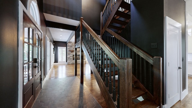 stairway featuring french doors and wood-type flooring