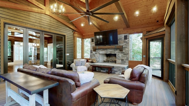 living room with lofted ceiling with beams, a healthy amount of sunlight, and wood ceiling