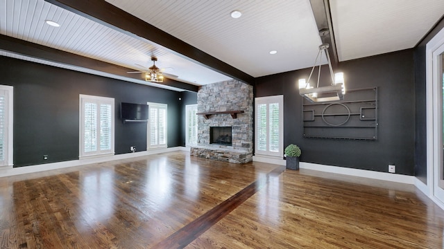 unfurnished living room with a fireplace, a wealth of natural light, and hardwood / wood-style floors