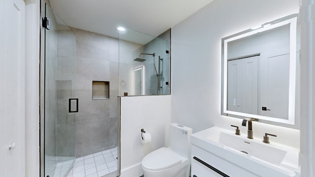 bathroom with toilet, vanity, and walk in shower