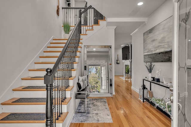 stairs featuring hardwood / wood-style floors