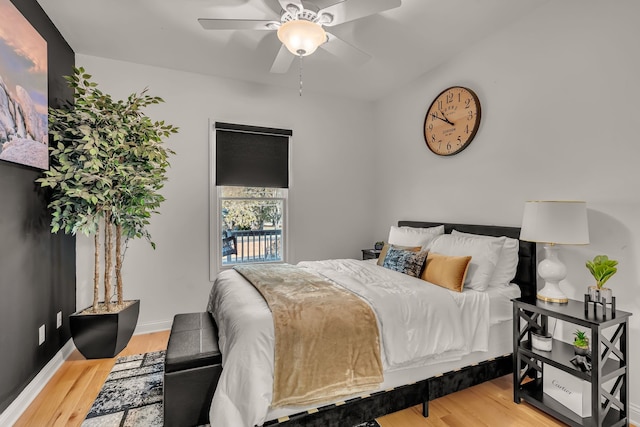 bedroom with hardwood / wood-style floors and ceiling fan