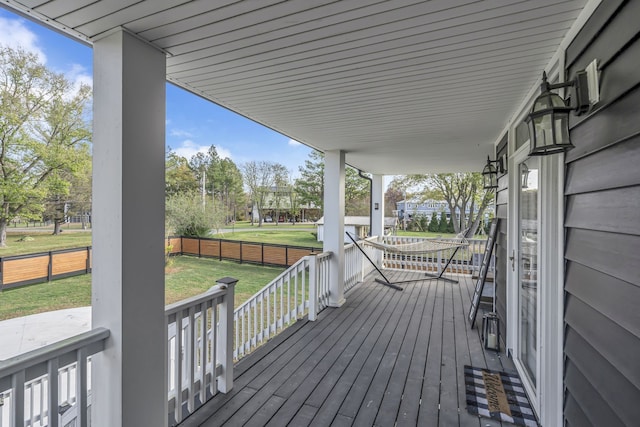 wooden deck featuring a lawn