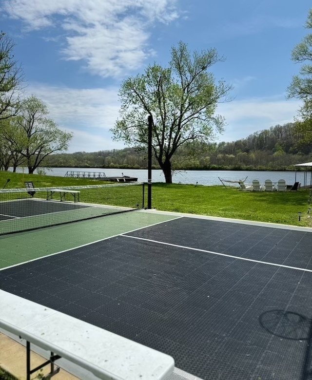 exterior space featuring a water view and a lawn