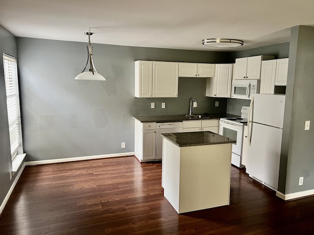 kitchen featuring white cabinetry, decorative light fixtures, dark hardwood / wood-style floors, sink, and white appliances