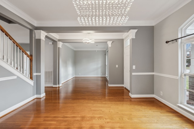 interior space featuring light hardwood / wood-style flooring, a healthy amount of sunlight, and crown molding