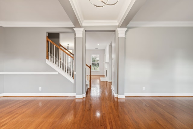 entryway with ornamental molding and hardwood / wood-style flooring