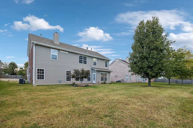 back of property with cooling unit, a lawn, and a patio area