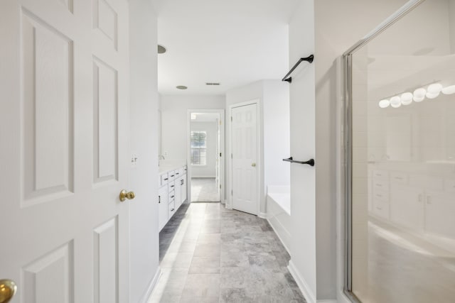 bathroom featuring vanity, tile patterned floors, and plus walk in shower