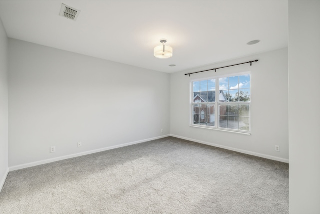 unfurnished room featuring carpet