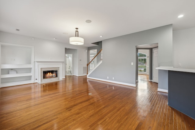 unfurnished living room with hardwood / wood-style floors