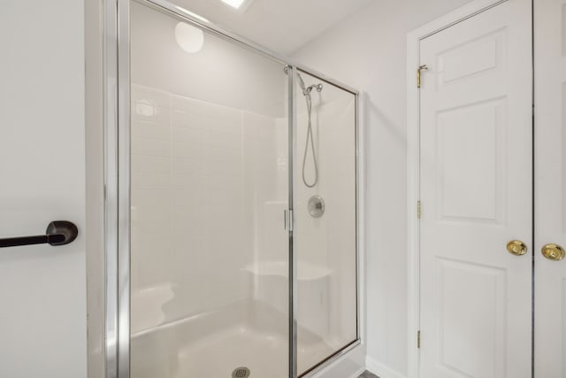 bathroom with a shower with shower door