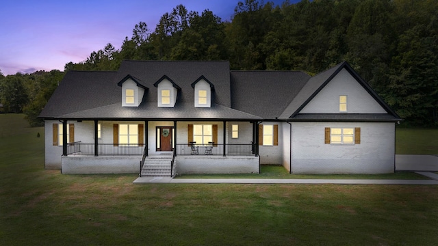 view of front of home with a lawn and a porch