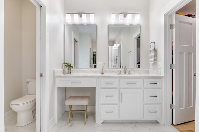 bathroom featuring toilet and vanity