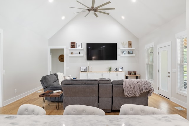 living room featuring high vaulted ceiling, light wood-type flooring, and ceiling fan