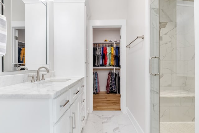 bathroom with vanity, wood-type flooring, and a shower with door