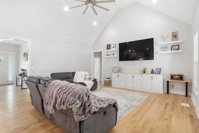 living room featuring high vaulted ceiling, light wood-type flooring, and ceiling fan