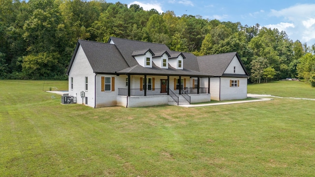 view of front of property with central air condition unit and a front yard