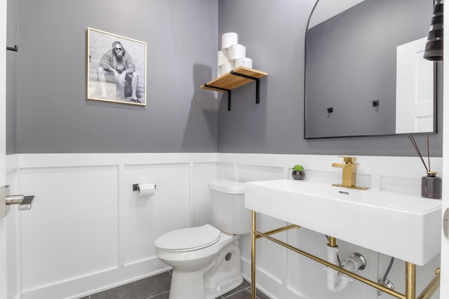 bathroom featuring tile patterned flooring and toilet