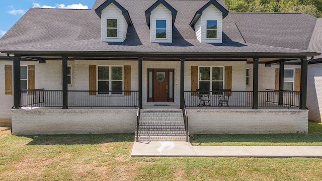 view of front of house featuring covered porch and a front yard