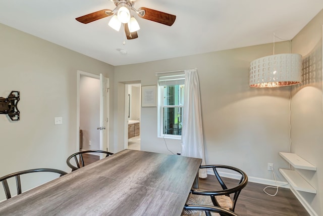 dining area with a ceiling fan, baseboards, and wood finished floors