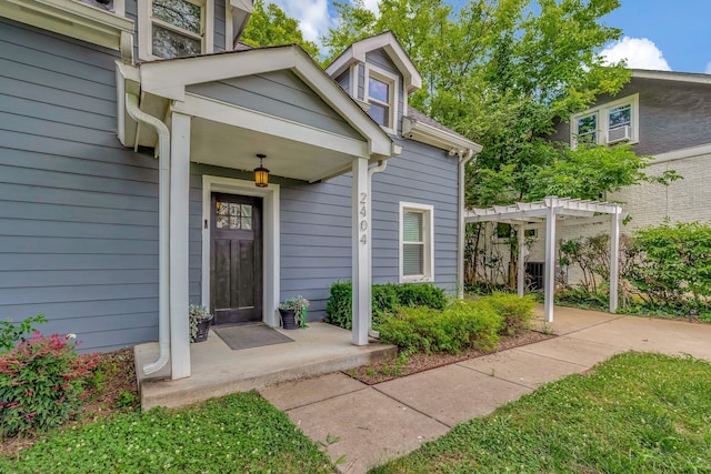 doorway to property with a pergola