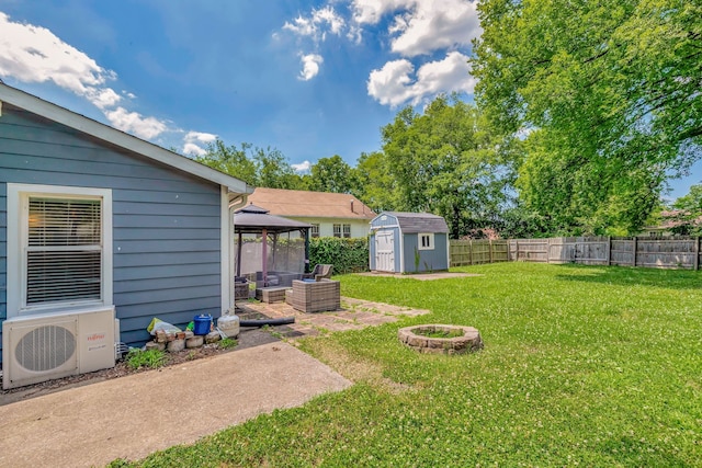 view of yard featuring ac unit, an outbuilding, a gazebo, a shed, and a fenced backyard