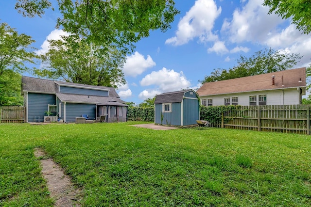 view of yard with a shed, an outdoor structure, and a fenced backyard