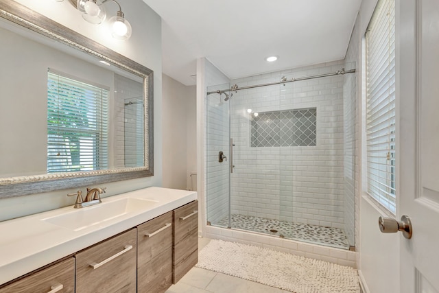 full bathroom featuring a stall shower, tile patterned flooring, and vanity