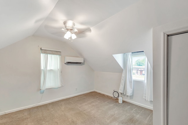 bonus room with baseboards, ceiling fan, carpet, vaulted ceiling, and an AC wall unit