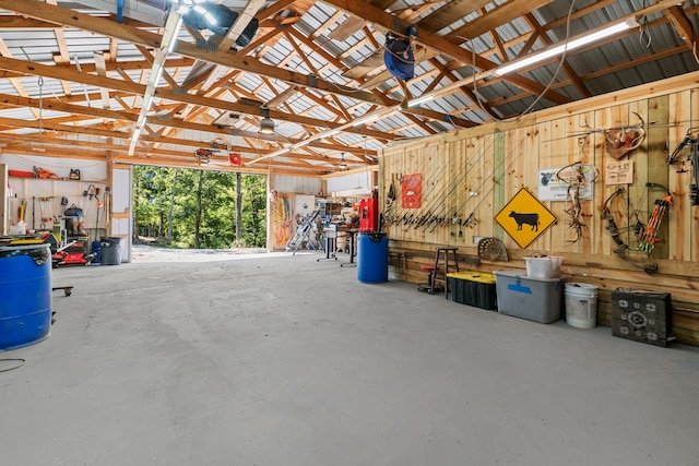 garage featuring a workshop area and wooden walls