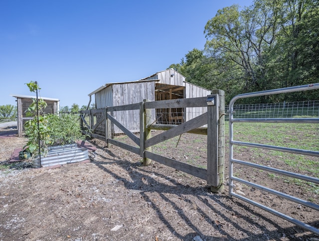 view of gate with an outdoor structure