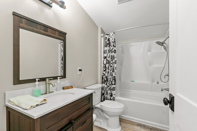 full bathroom with shower / bath combo, vanity, hardwood / wood-style flooring, and toilet