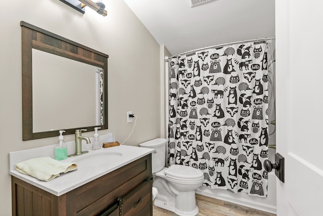 full bathroom featuring wood-type flooring, vanity, toilet, and shower / bath combo with shower curtain