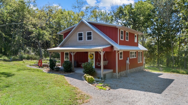 view of front of house with covered porch and a front yard