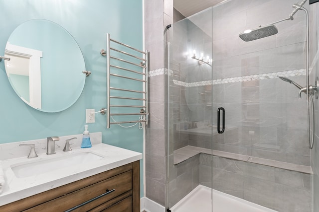 bathroom featuring vanity, radiator heating unit, and walk in shower