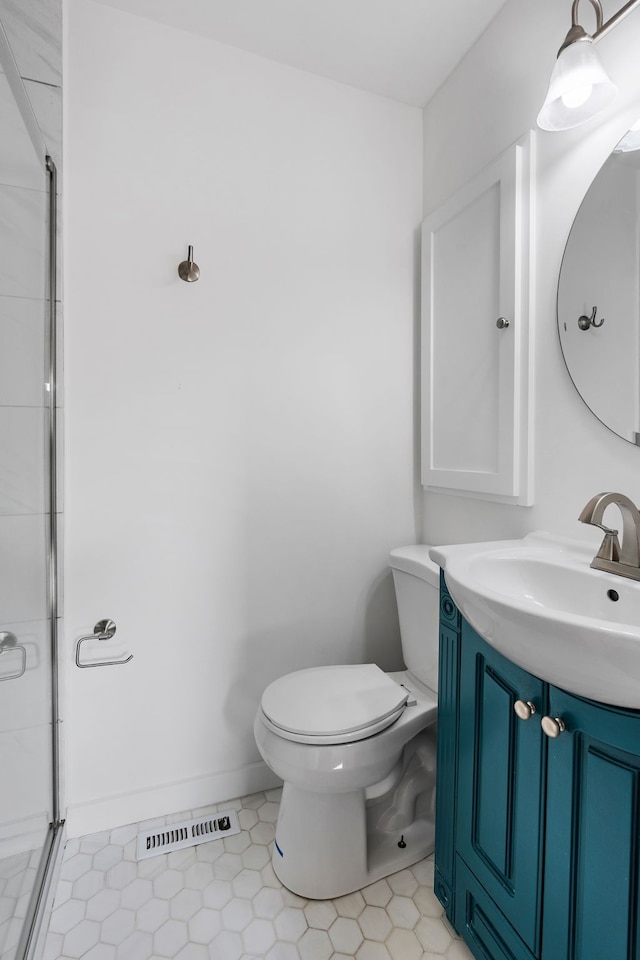 bathroom featuring walk in shower, tile patterned flooring, vanity, and toilet