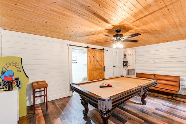 recreation room with dark hardwood / wood-style flooring, wooden walls, wood ceiling, and a barn door