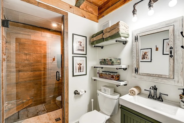 bathroom featuring an enclosed shower, vanity, and toilet